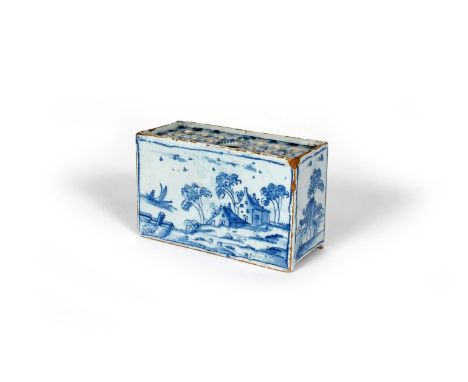 A delftware flower brick, c.1760, of rectangular form, the long sides painted with landscape scenes of figures in boats besid