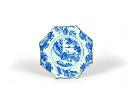 A small delftware octagonal plate, c.1690, probably London, painted in blue with a Chinese figure seated in a landscape, the 