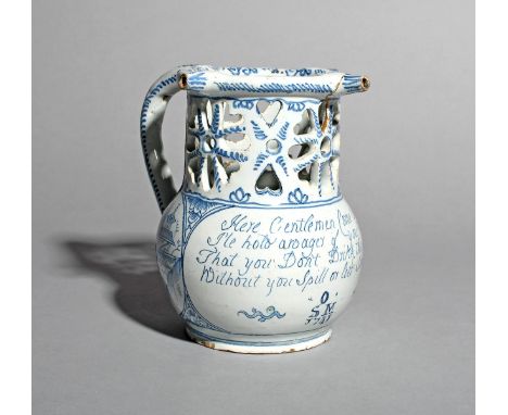 A rare delftware puzzle jug, dated 1741, the globular body inscribed with the traditional four line wager above the inscripti