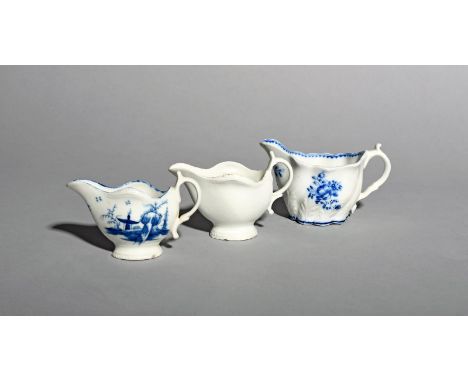 Three Caughley creamers, c.1780-85, one painted in underglaze blue with the Rock House Island pattern, another left in the wh