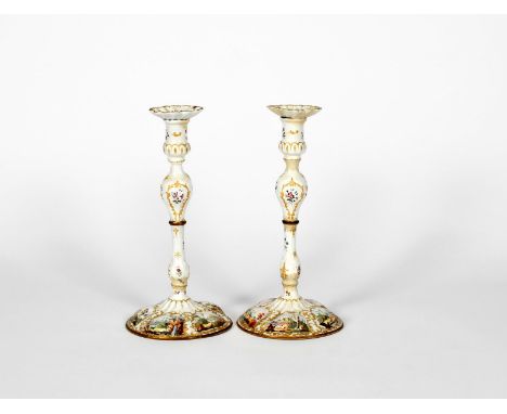 A large pair of Staffordshire enamel candlesticks, c.1770, the lobed bases painted with scenes of sheep amidst trees and Clas