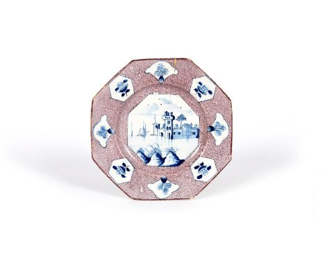 A Wincanton delftware octagonal plate, c.1740, the well painted in blue with a soldier guarding a harbour fortress, reserved 