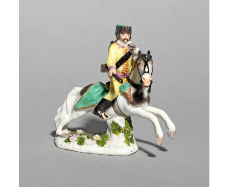 A miniature Meissen figure of a Hussar, mid 18th century, modelled on horseback, his gun in his right hand, holding the reins