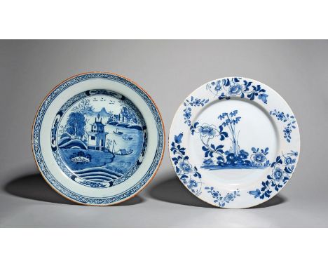 Two delftware chargers, c.1740-60, one painted with flowering peony and stems of bamboo, with flower sprays echoed to the rim