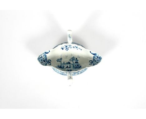 A Worcester blue and white two-handled sauceboat, c.1756, painted with the Two-Handled Sauceboat pattern, the interior with a