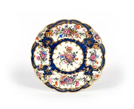 A large Worcester dish or stand, c.1760-70, painted with sprays and garlands of colourful flowers reserved within gilt scroll