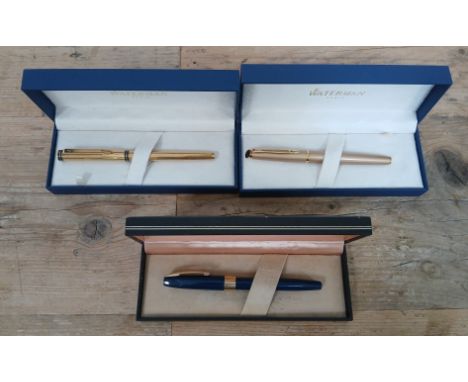 A group of three fountain pens comprising a Waterman with 18K nib, another Waterman and a Sheaffer.