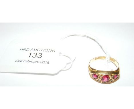 A three stone ruby ring in 18ct gold setting 