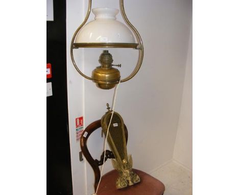 A hanging oil lamp with milk glass shade, converted to electricity, together with a brass fireguard and Victorian chair 