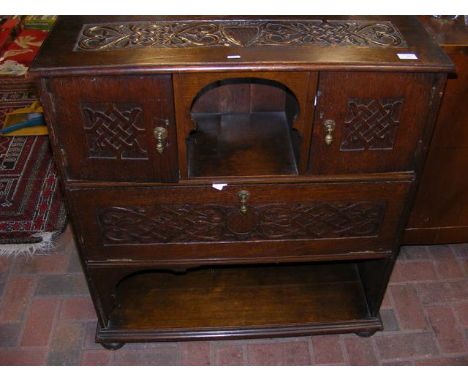 A carved oak side cabinet 