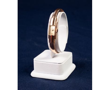 LADY'S BAUME &amp; MERCIER, GENEVE, 18ct GOLD SPRUNG BANGLE WATCH with mechanical movement, tiny oblong silvered dial with fo