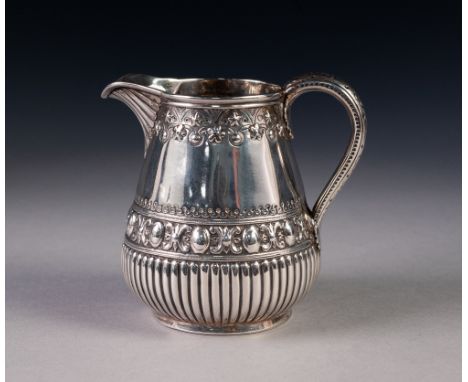 GOOD QUALITY VICTORIAN SILVER CREAM JUG, the pear shaped body demi-gadrooned and embossed with formal vorders, gadrooned spou