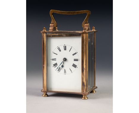 A MID TWENTIETH CENTURY BRASS CASED CARRIAGE CLOCK of typical form with oblong white dial, black Roman numerals, 5 1/4" (13.3
