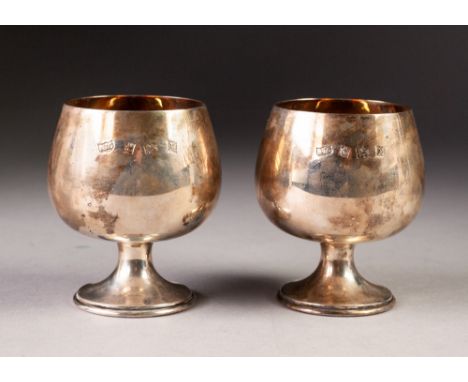 PAIR OF SILVER BRANDY BALLOONS on short waisted stems and stepped circular bases, gilt interiors, 3 1/4" high, Birmingham 197