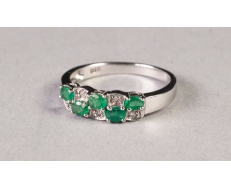 10k WHITE GOLD, DIAMOND AND EMERALD RING, with a two row over and under setting of five tiny diamonds, and six tiny emeralds,