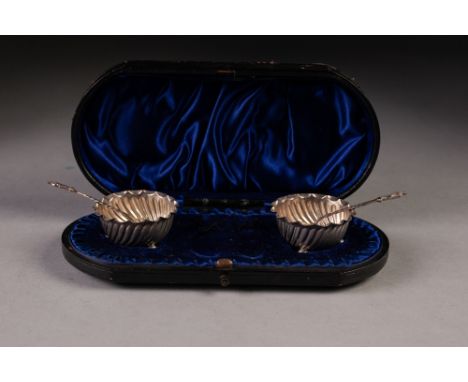 PAIR OF VICTORIAN SILVER CIRCULAR SALT RECEIVERS, spirally fluted with crimped edge, on three ball feet, 1 3/4" diameter and 