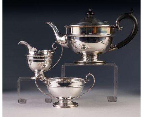 PRE-WAR THREE PIECE SILVER TEA SERVICE OF CIRCULAR PEDESTAL FORM, the teapot with blackwood handle and knop, teapot Birmingha