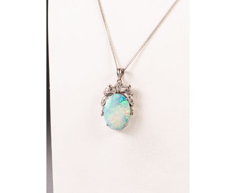 14k WHITE GOLD PENDANT, with an oval opal, 2cm x 1.5cm in a four claw setting with fancy foliate top, 4.7gms, on a silver fin