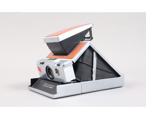 A Polaroid SX-70 Land Camera, tan, untested, body G, slight wear, bellows G-VG, elements G-VG, with SX-70 manual, in Polaroid