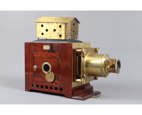 An early 20th Century Mahogany and Brass Newton and Co Magic Lantern,  in wooden case, with integral adjustable projection st