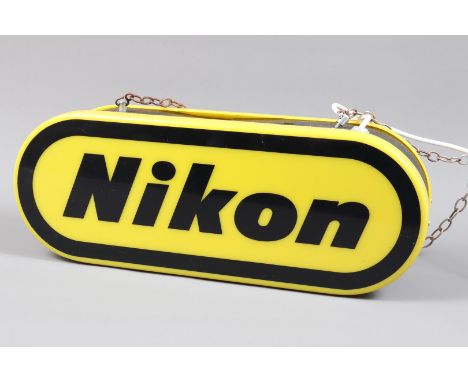 A Nikon Illuminated Shop Advertising Sign, with Nikon logo, yellow background with black lettering, 40W lamp inside, not work