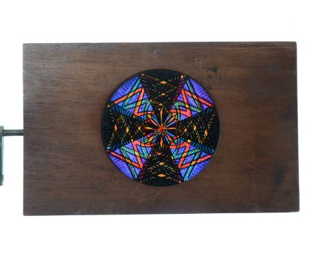 Mahogany-Mounted Magic Lantern Slides,  hand-coloured rackwork chromatropes or artificial fireworks, inset brass rings - geom