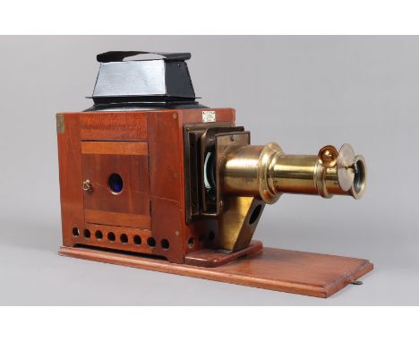 A late 19th Century Mahogany and Brass Newton and Co Magic Lantern,  in wooden case, G, cowl and chimney repainted, lacks ill