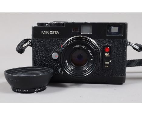 A Minolta CLE Compact Rangefinder Camera, serial no 1001532, body F, moderate edge wear and scuffing, shutter timing faulty a