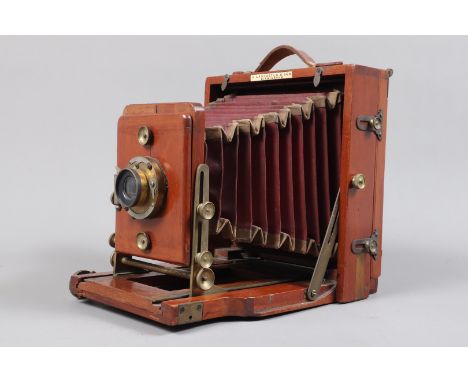 A J. Lancaster &amp; Son Instantograph Half Plate Field Camera, mid 1890s, carrying strap, square-cornered red bellows F, tap