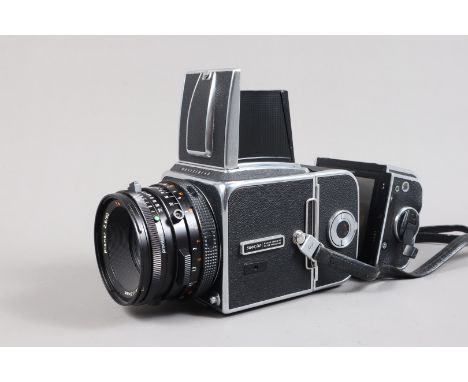 A Hasselblad 500C/M SLR Camera, serial no RV 1253518, year 1981, body G, dust to mirror, shutter working, a Carl Zeiss Planar