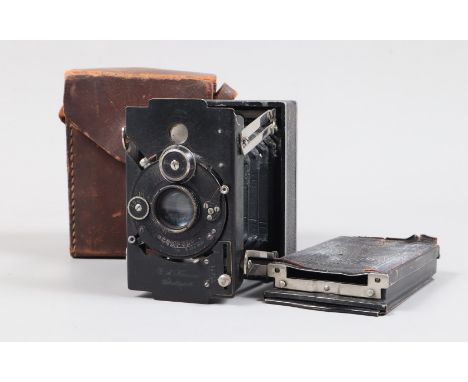 A Krauss Stuttgart Knirps Folding Strutt Camera,  circa 1920, Compur shutter working, focusing working, body G, bellows G, li