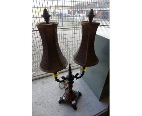 An Italian style black and gilt two branch table lamp