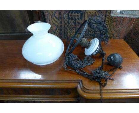 A vintage hanging glass oil lamp