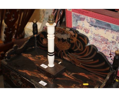 An Art Deco ivory and ebony candlestick table lamp