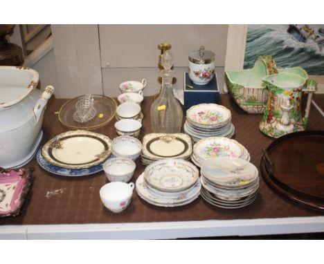 A pair of Victorian brass candlesticks; various china tea cups and saucers; a glass decanter; a large coddler etc.