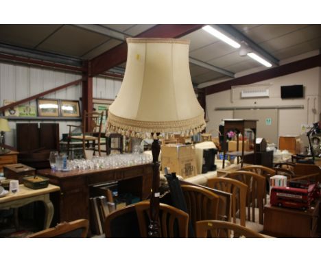 A mahogany standard lamp and shade