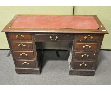 A mahogany kneehole desk, inset with leather top, with four drawers to either side, 20th century, 79 cm high x 122 cm wide x 