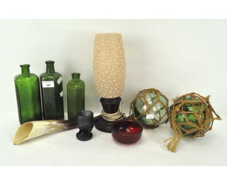 A Bakelite lamp base, two glass fishing weights, a poison bottle and other items