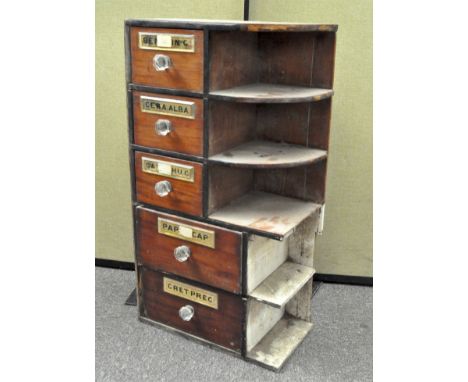 A 20th century chemist's apothecary corner cabinet, comprising three short and three long drawers next to five small shelves,