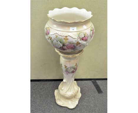 A 20th century ceramic jardiniere on stand, decorated with floral sprays amongst gilt leaves, 86cm high