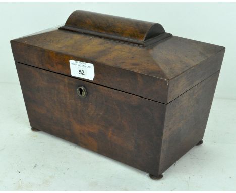 A Victorian mahogany tea caddy of sarcophagus form, the lid opening to reveal one lidded compartment and a space for a mixing