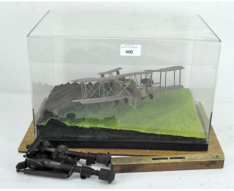 A model bi-plane, twin engined, in display case, together with a brass front spirit level and another item