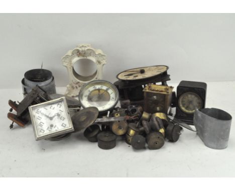 An assortment of clock movements and mechanisms, some with dials, including "The Gledhill-Brook Time Recorders Ltd, Huddersfi