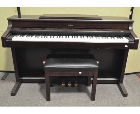 A Rowland digital piano, HP557R and adjustable stool in a mahogany effect finish, 144cm wide, lacking power cable