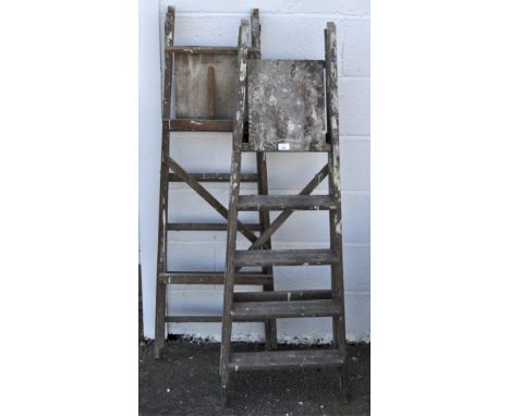 Two pairs of wooden step ladders, the tallest 141 cm high