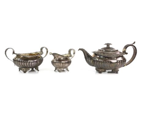 Near matched George III/Victorian silver three piece tea service, comprising teapot, cream jug and sugar bowl with scrolling 