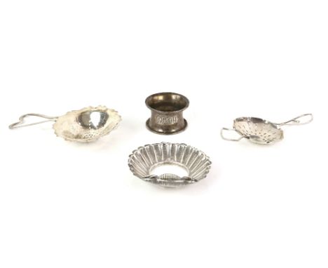 Two silver tea strainers, a silver napkin ring and an 800 grade silver shell dish, largest strainer 13.5 cm, 110 gr. (4)     