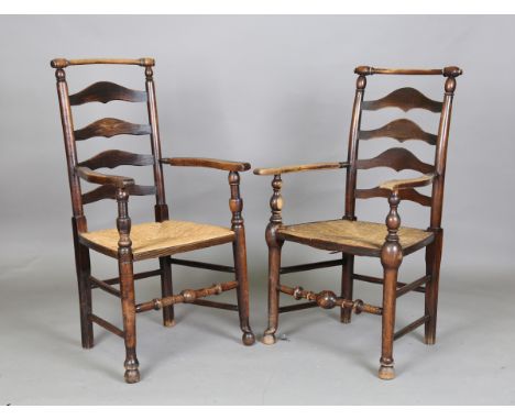 A near pair of 18th century and later provincial ash ladder back armchairs with turned top rails and rush seats, height 103cm
