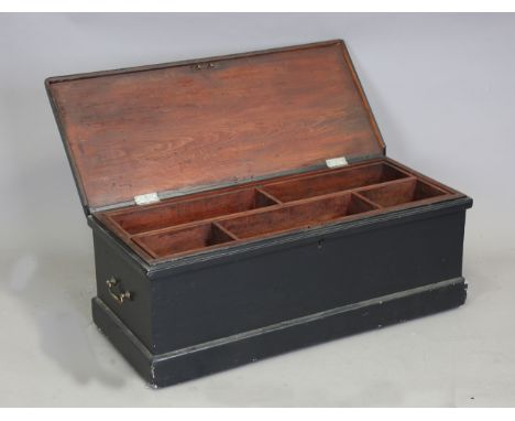 A late 19th century black painted pine carpenter's chest with hinged lid, two lift-out trays and a small collection of tools,