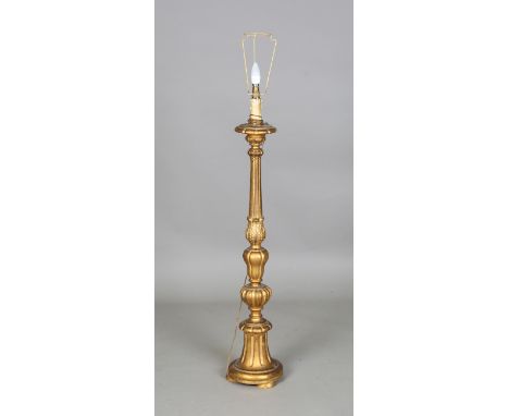 An early 20th century Italianate carved giltwood standard lamp of reeded and circular fluted form, height 101cm.Buyer’s Premi